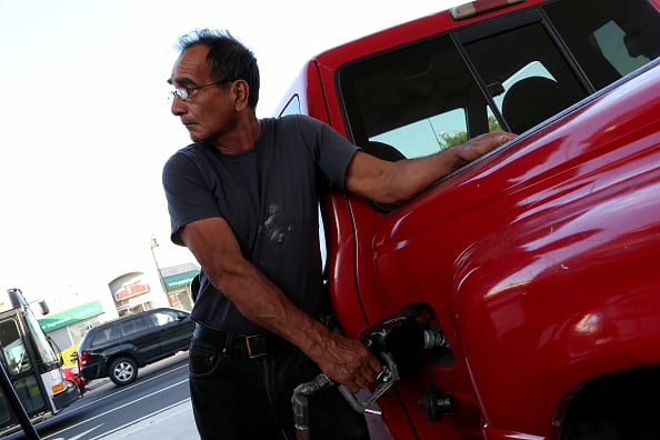 Man pumping gas into his car Man pumping gas into his car