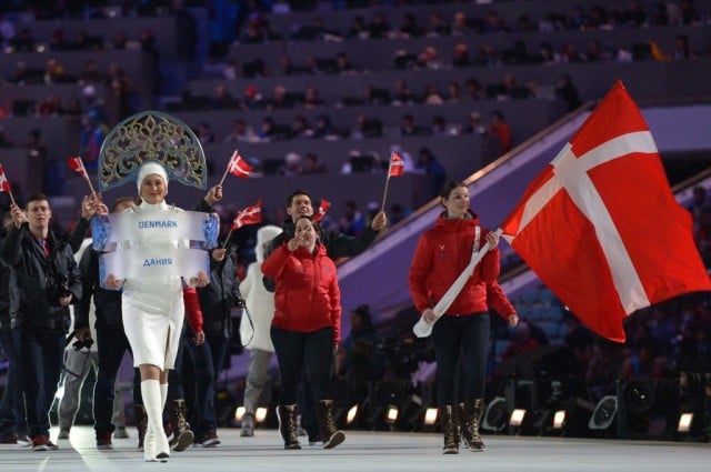 Denmark's flag bearer, curler Lene Nielsen leads his national delegation during the Opening Ceremony of the Sochi Winter Olympics at the Fisht Olympic Stadium on February 7, 2014 in Sochi. (Photo by Alberto Pizzoli/AFP/Getty Images)