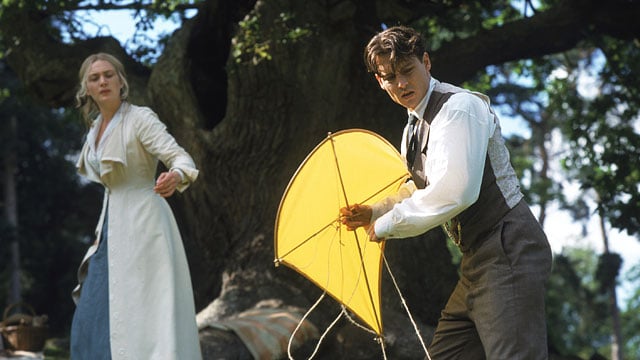 Johnny Depp holds a yellow kite and stands next to Kate Winslet in 'Finding Neverland' 