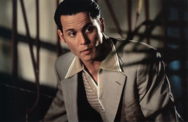 Johnny Depp wears a gray suit and stares to the left in 'Donnie Brasco'. Johnny Depp wears a gray suit and stares to the left in 'Donnie Brasco'.