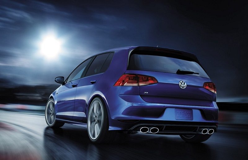 A dark blue 2017 Volkswagen Golf R rides the open road at night