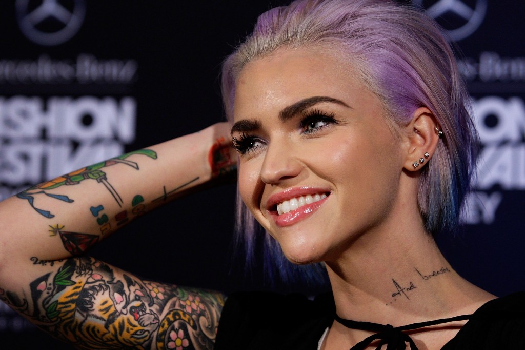 Ruby Rose smiles and holds up her arm
