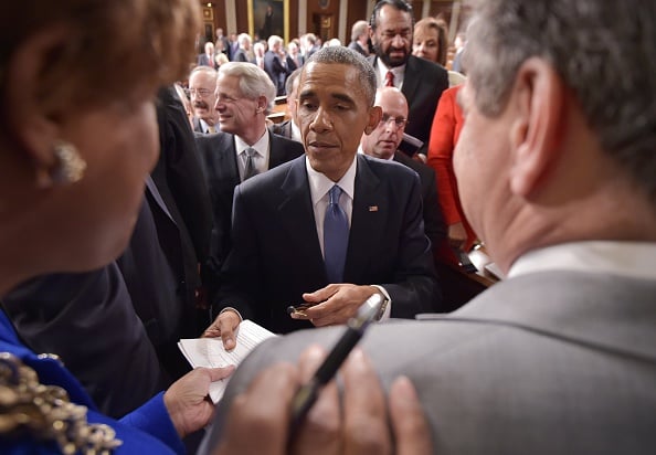 US President Barack Obama signs autographs after delivering the State of the Union address before a joint session of Congress on January 20, 2015 at the US Capitol in Washington, DC. AFP PHOTO/POOL/MANDEL NGAN (Photo credit should read MANDEL NGAN/AFP/Getty Images)