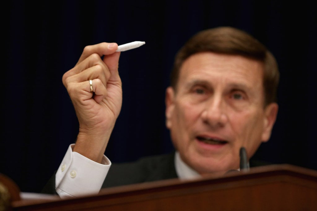 John Mica (R-FL) holds a fake hand-rolled cigarette during a hearing about marijuana laws in 2014