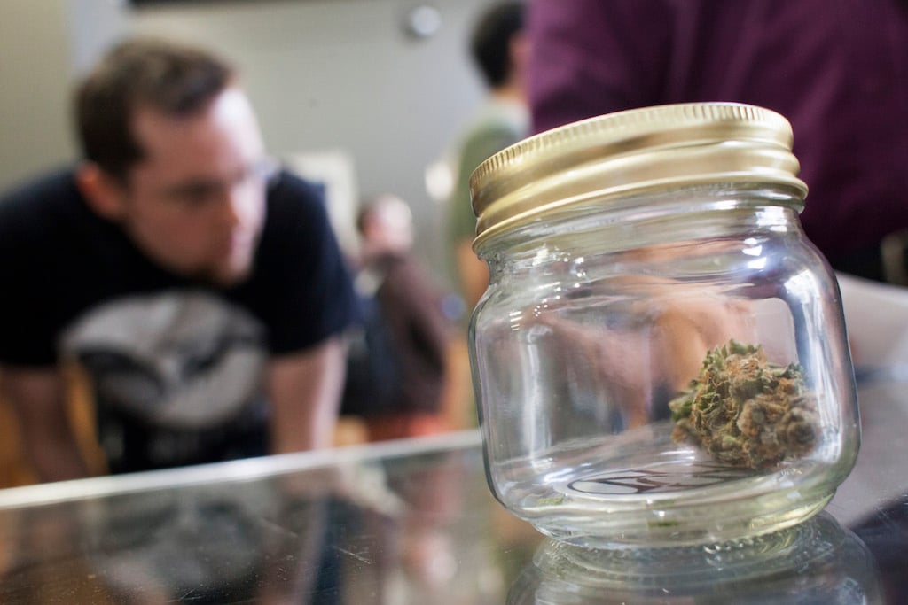 Customers shop for marijuana at Top Shelf Cannabis, a retail marijuana store, on July 8, 2014 in Bellingham, Washington. Top Shelf Cannabis was the first retail marijuana store to open today in Washington state, nearly a year and a half after the state's voters chose to legalize marijuana. (Photo by David Ryder/Getty Images)