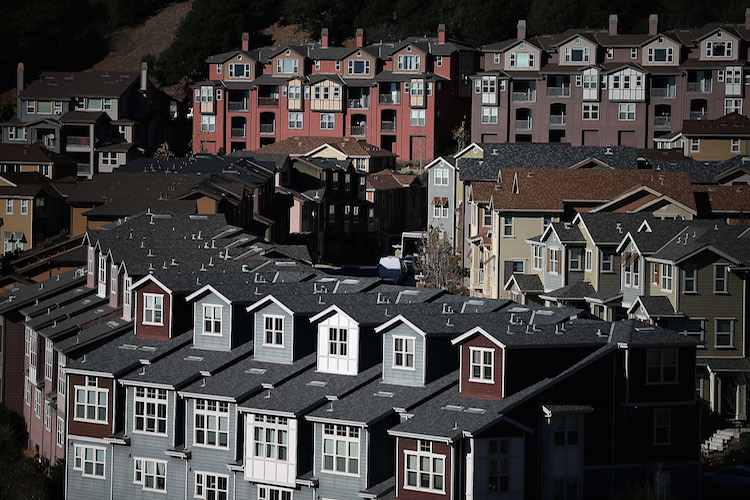 Rows of new homes line a street in a housing development on December 4, 2013 in Oakland, California. (Photo by Justin Sullivan/Getty Images)