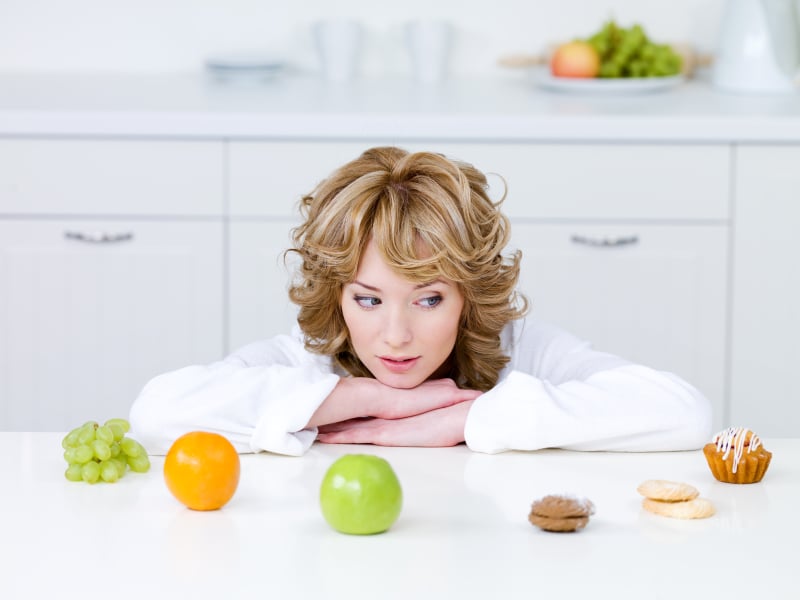 Woman deciding what to eat Woman deciding what to eat