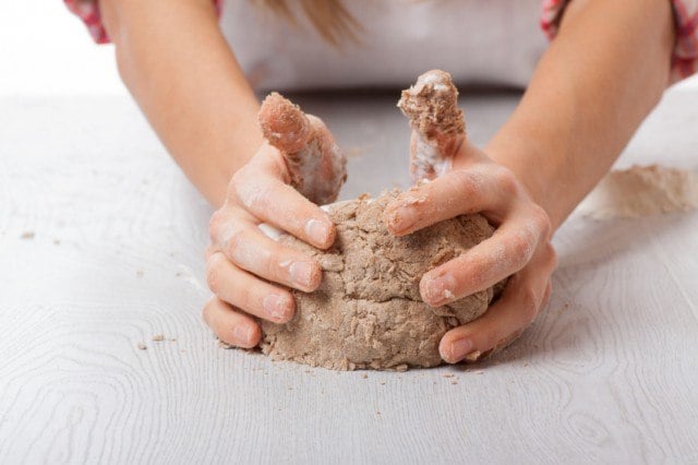 hands knead rye wheat dough