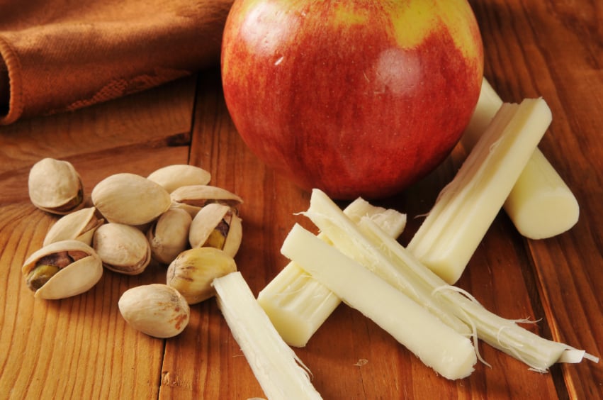Apples and string cheese on a wooden table