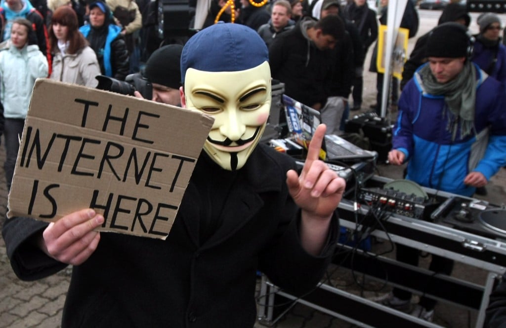 An activist in a Guy Fawkes mask dances in front of a DJ during a demonstration against the Anti-Counterfeiting Trade Agreement (ACTA) on February 25, 2012 in Berlin, Germany. ACTA is a proposed treaty attempting to establish an international governing body with legal standards intended to protect intellectual property and prevent the production and sale of counterfeit goods. The German government has delayed a decision on the agreement, citing concerns by the Justice Ministry, and according to news reports is waiting for approval by the European Parliament prior to signing the multinational treaty. (Photo by Adam Berry/Getty Images)