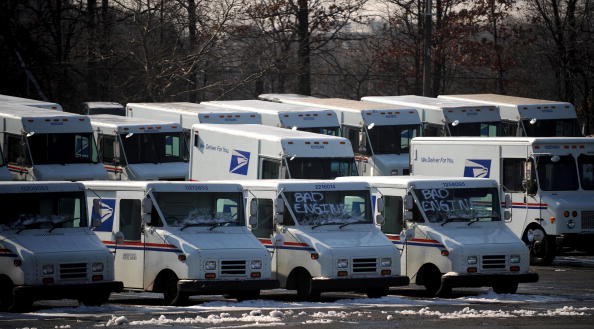 USPS trucks in a lot