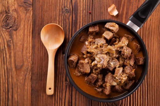 Beef stew - wooden background