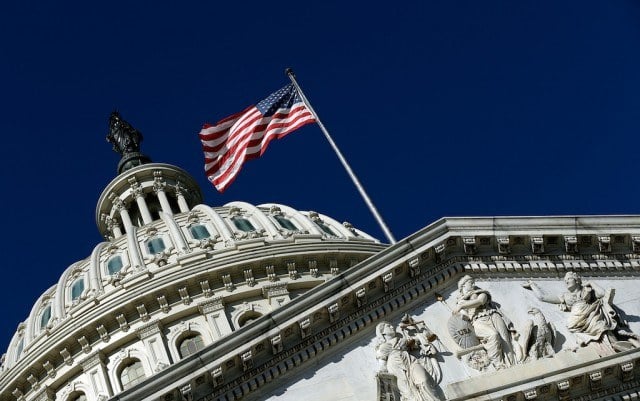 An American flag waves outside the United States Capitol building as Congress remains gridlocked over legislation to continue funding the federal government September 29, 2013 in Washington, DC. The House of Representatives passed a continuing resolution with language to defund U.S. President Barack Obama's national health care plan yesterday, but Senate Majority Leader Harry Reid has indicated the U.S. Senate will not consider the legislation as passed by the House. (Photo by Win McNamee/Getty Images)