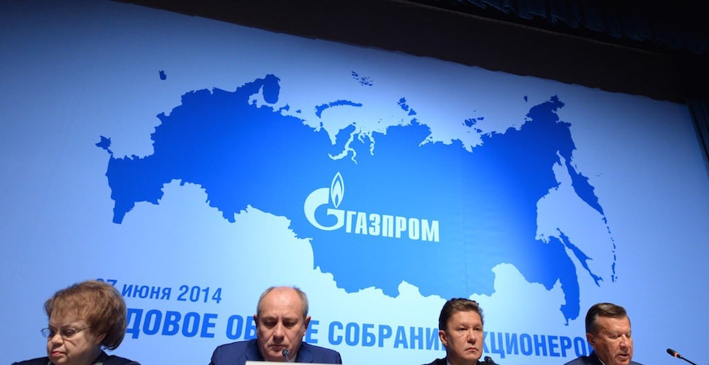 Russia's gas giant Gazprom CEO, Alexei Miller (2nd R), and Gazprom's board of directors chairman, Viktor Zubkov (R), attend the world biggest gas company's annual meeting in Moscow, on June 27, 2014, with the logo of Gazprom in the background. The Russia's map in the background includes the Crimea peninsula. Crimea's largely Russian-speaking residents voted in March to become part of Russia, in a hastily organised referendum held as Russian troops patrolled the region. Photo by Vasily Maximov/AFP/Getty Images.