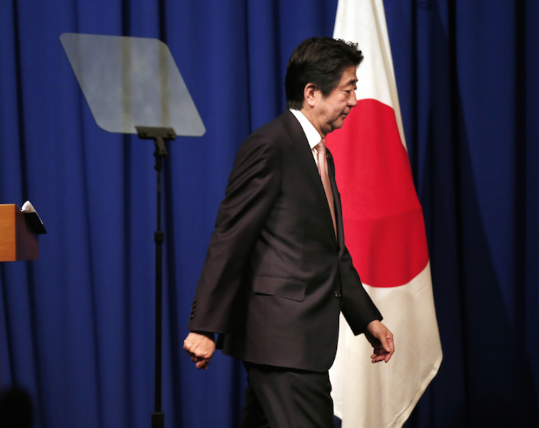 Shinzo Abe walks off stage at a press conference Shinzo Abe walks off stage at a press conference