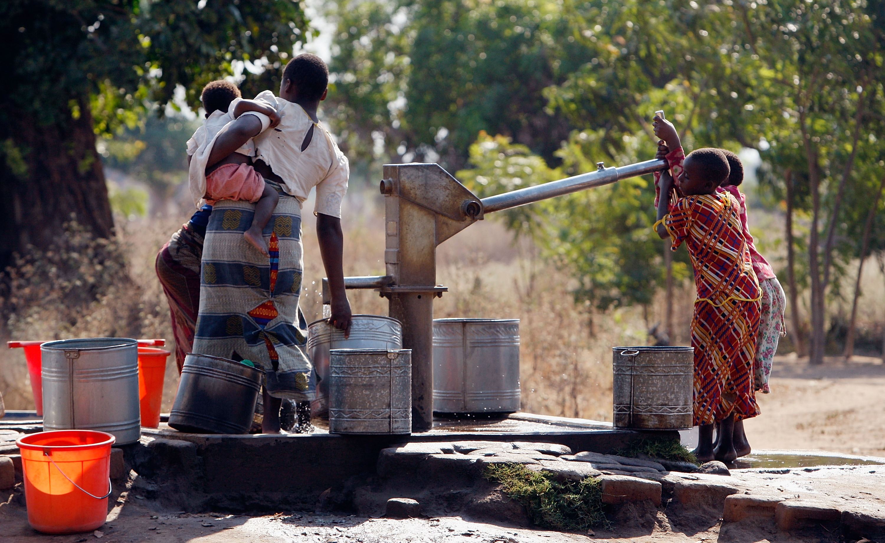 Children pump water in Ligwangwa, Malawi