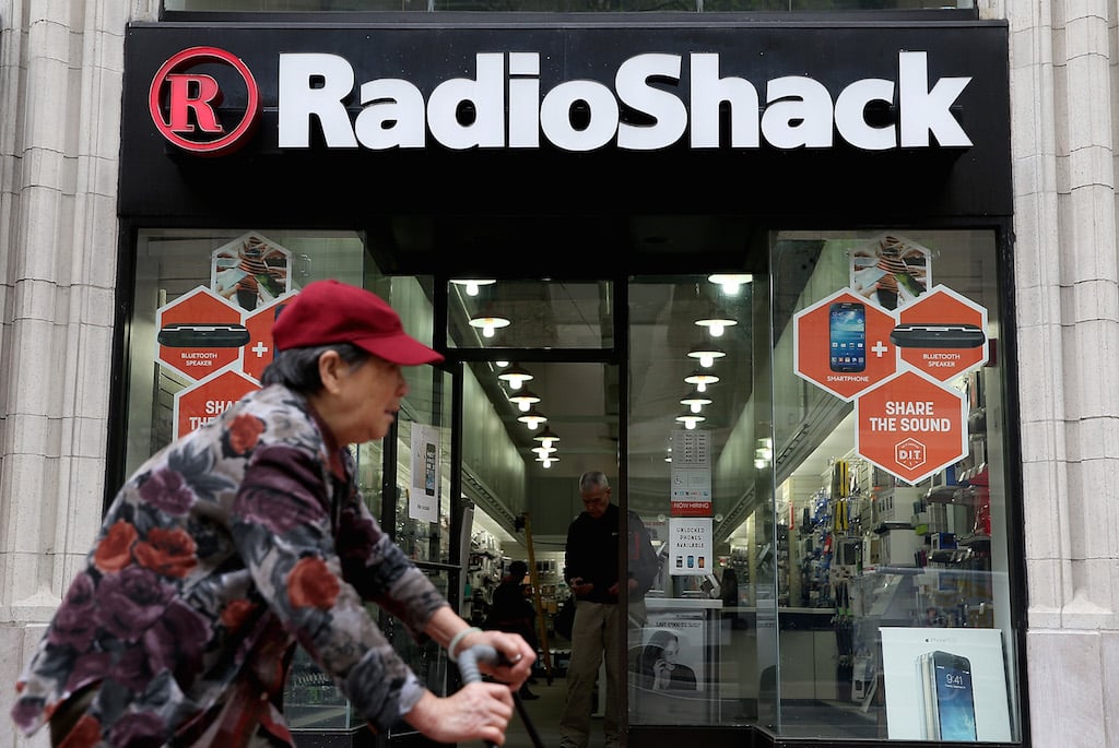 A person rides by a Radio Shack store on March 4, 2014 in San Francisco, California. RadioShack announced plans to close over 1,000 of its underperforming stores, approximately 20 percent of its retail locations, as part of a restructuring to be more competitive in retail electronics. (Photo by Justin Sullivan/Getty Images)