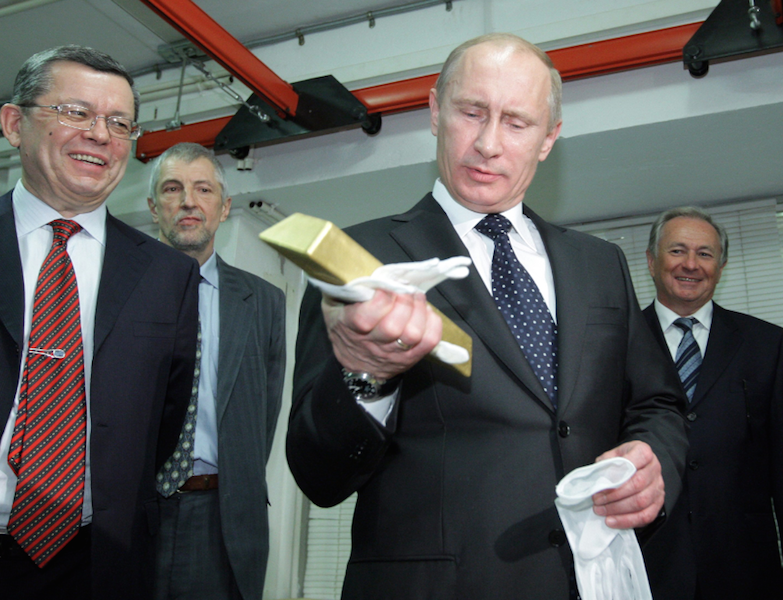 Russia president Vladamir Putin holding a gold bar