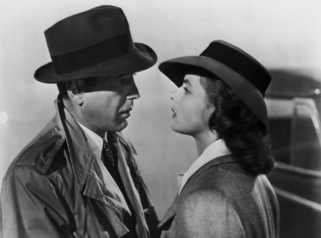 A black and white still of a man and woman staring at each other A black and white still of a man and woman staring at each other