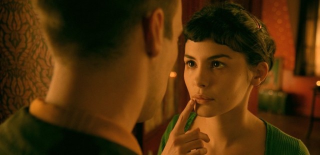 A man holds up a finger to a woman's lips A man holds up a finger to a woman's lips