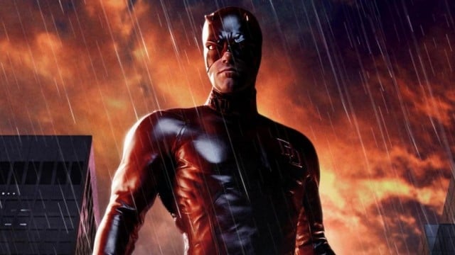 Ben Affleck wears the Daredevil costume while standing in the rain