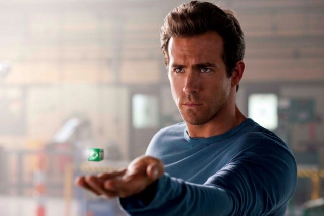 Ryan Reynolds stares ahead and holds up a green ring in The Green Lantern