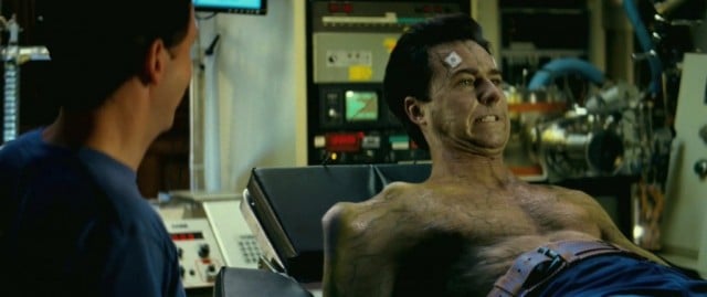 Edward Norton lays on a bed and grimaces in The Incredible Hulk 