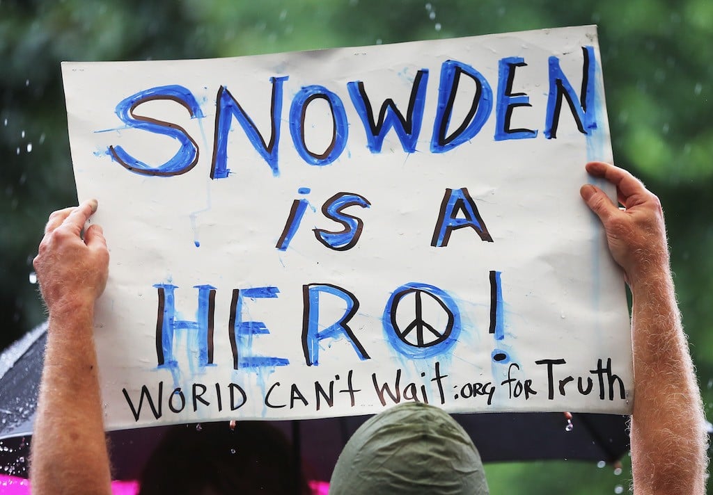 A supporter holds a sign at a small rally in support of National Security Administration (NSA) whistleblower Edward Snowden in Manhattan's Union Square on June 10, 2013 in New York City. About 15 supporters attended the rally a day after Snowden's identity was revealed in the leak of the existence of NSA data mining operations. (Photo by Mario Tama/Getty Images)