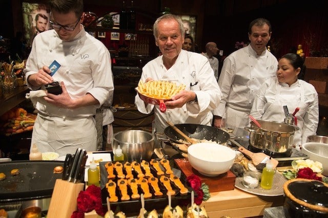Wolfgang Puck cooking with other chefs