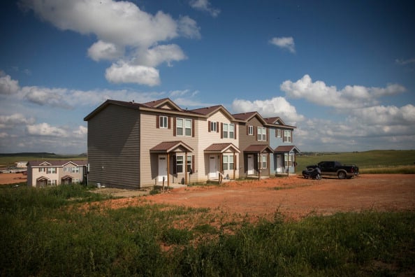 New townhouses are seen next to a highway in Watford City, North Dakota