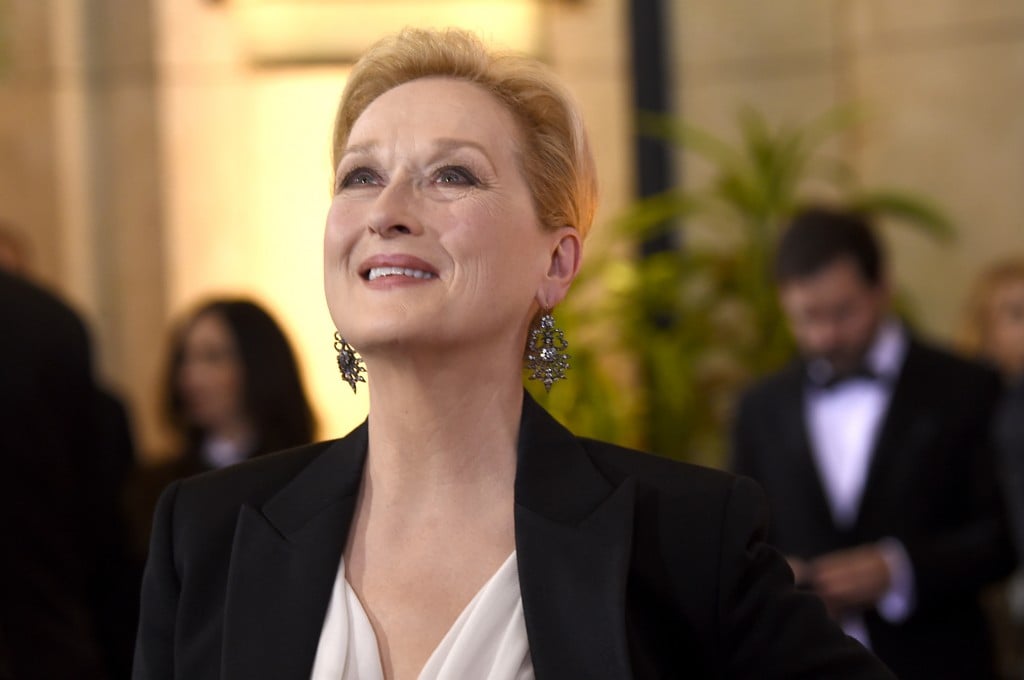 Meryl Streep looks upward while smiling and wearing a black blazer. Meryl Streep looks upward while smiling and wearing a black blazer.