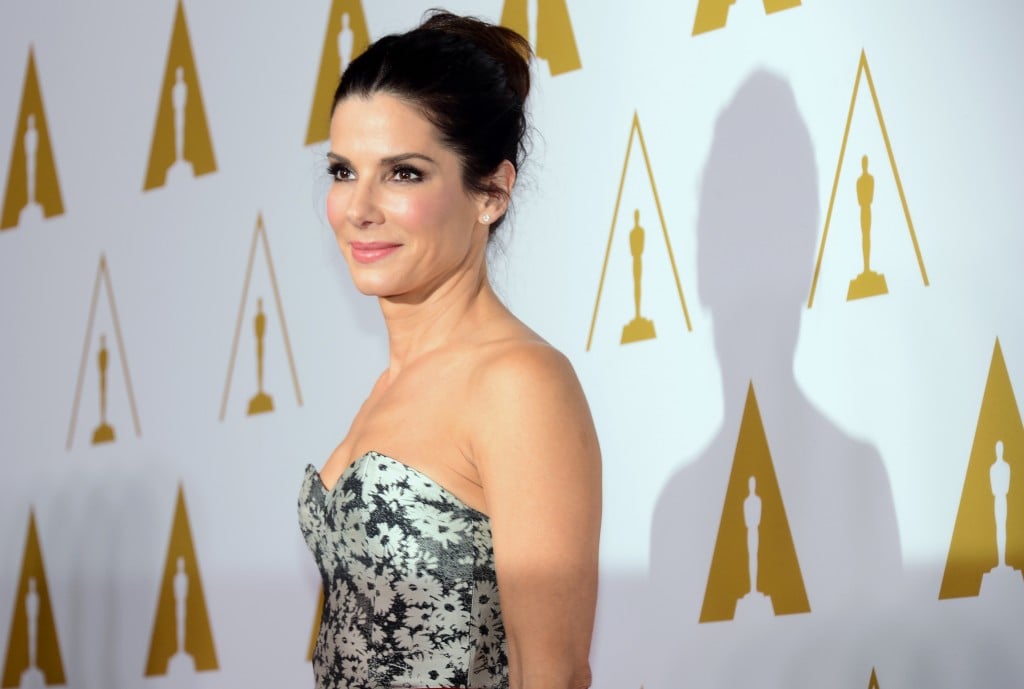Sandra Bullock poses for the paparazzi in a floral strapless dress. 