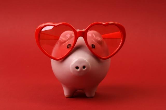 Piggy bank with heart sunglasses on