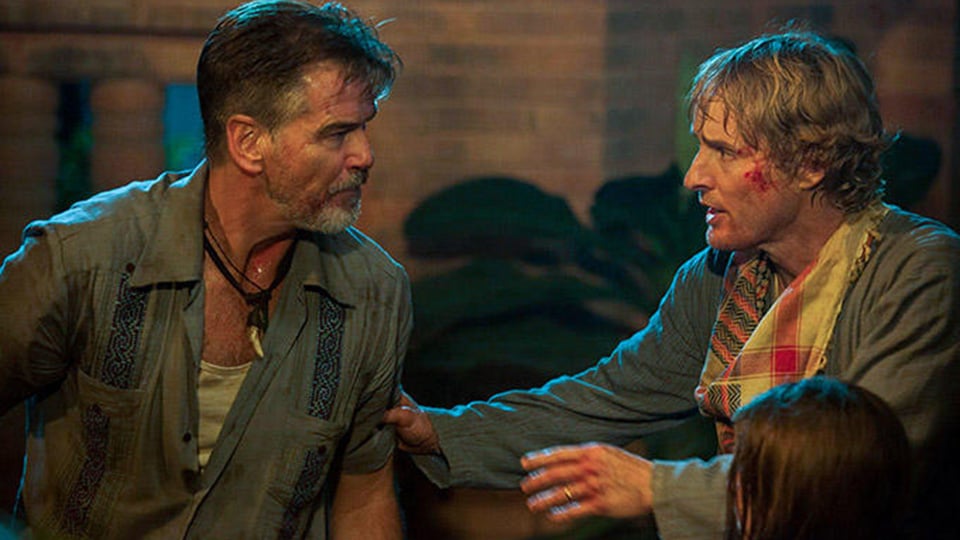 Pierce Brosnan talks to a bloodied Owen Wilson in No Escape 
