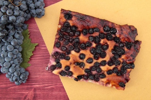 pizza focaccia with grapes on yellow paper