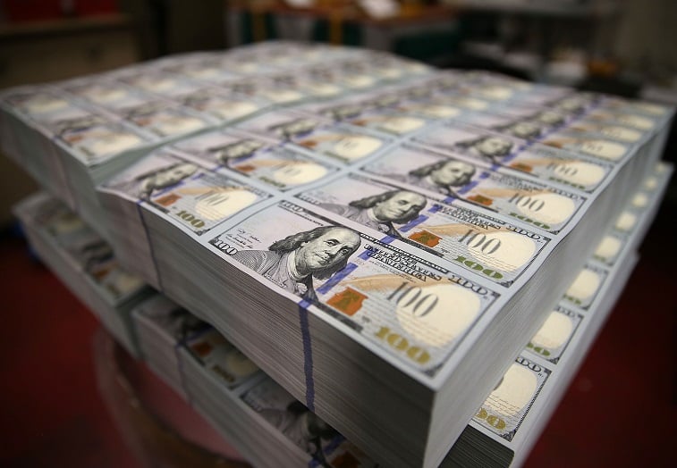 $100 notes lay in stacks at the Bureau of Engraving and Printing