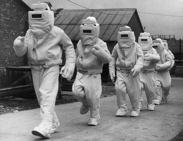 A demonstration of asbestos fire fighting suits - Source: William Vanderson/Fox Photos/Getty Images