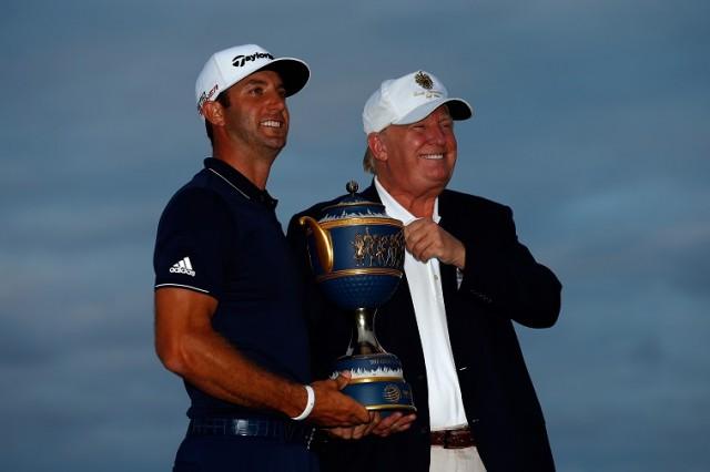 Dustin Johnson of the United States and Donald Trump pose with the Gene Sarazen Cup - Source: Sam Greenwood/Getty Images