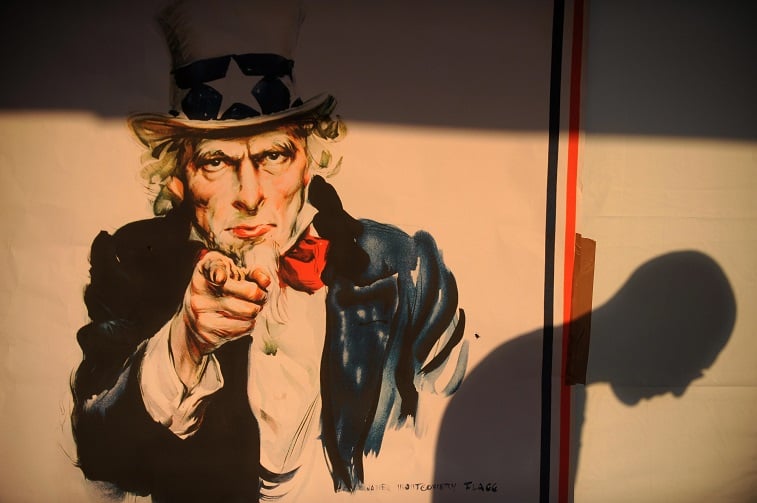 A shadow of a voter is seen on a poster of Uncle Sam