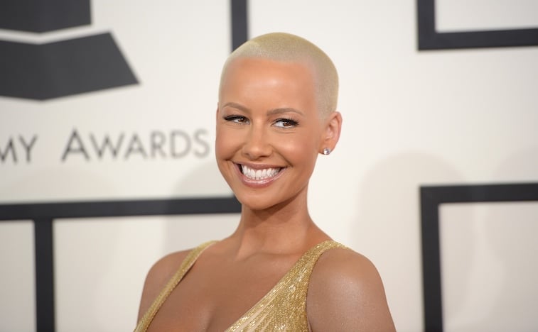 Amber Rose smiling in a yellow dress. 