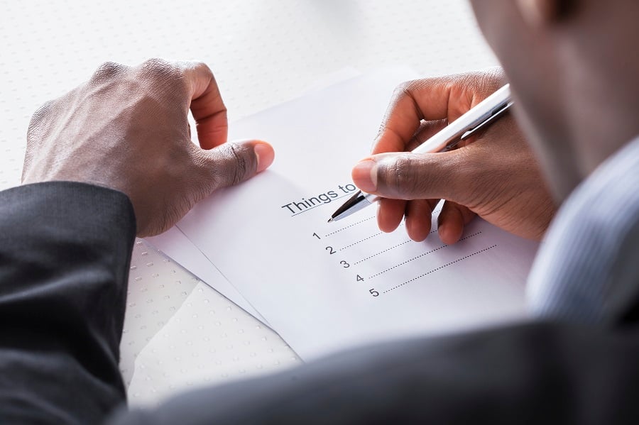 A man writes a to-do list A man writes a to-do list