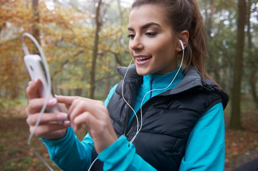 woman checking her phone and listening to music woman checking her phone and listening to music