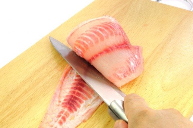 fresh tilapia being cut