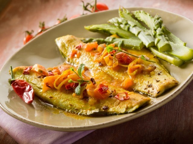 fish fillet with tomato hot chili pepper and asparagus