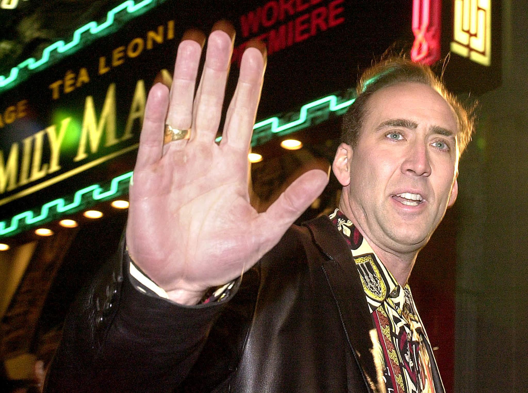 Nicolas Cage holds up his hand Nicolas Cage holds up his hand