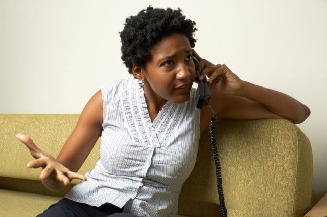 An African-American woman talks on the phone