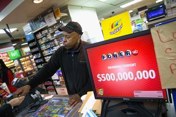 A man selling lottery tickets at a store. A man selling lottery tickets at a store.