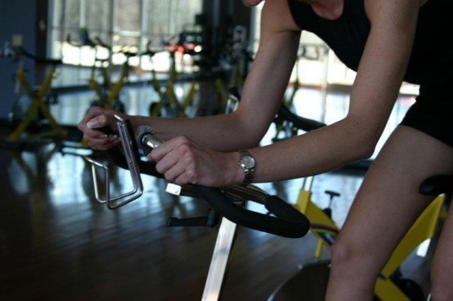 Woman at a spin class at her gym Woman at a spin class at her gym