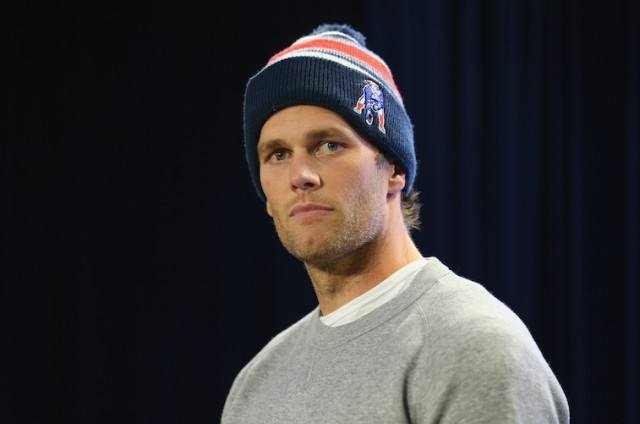 Tom Brady wearing a beanie and gray sweatshirt. Tom Brady wearing a beanie and gray sweatshirt.