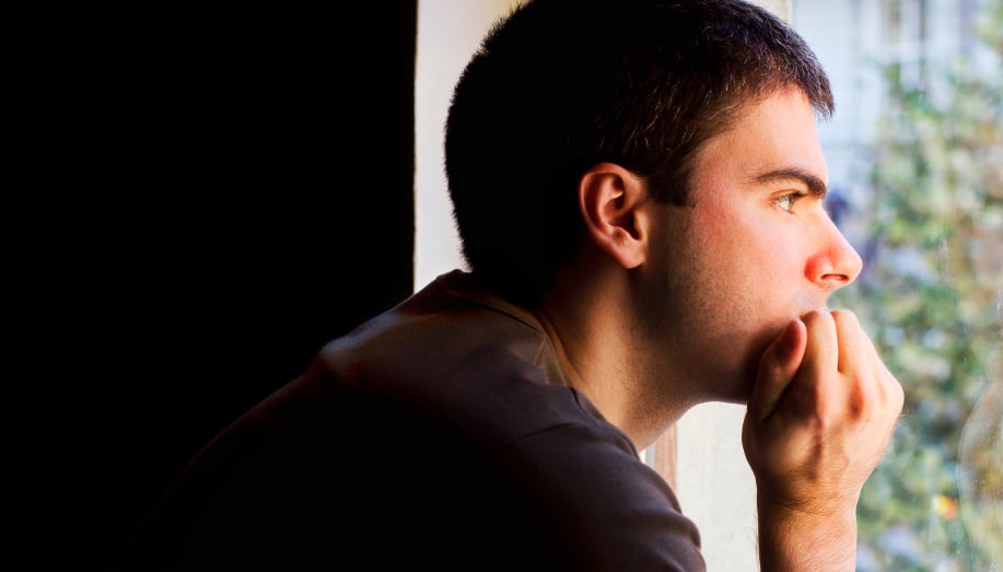 Lonely man staring out the window